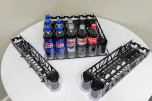 Pepsi and Coke bottles in plastic rack